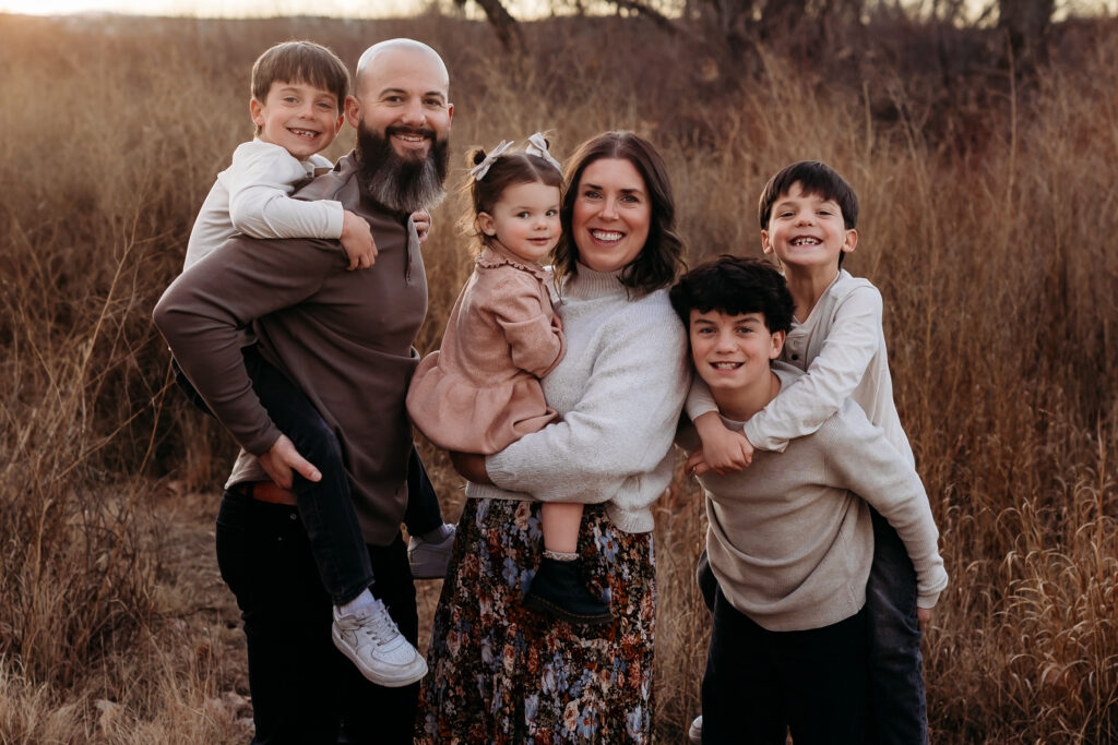 Husband, wife and four children during a playful family session | Reunion, CO Family Photography