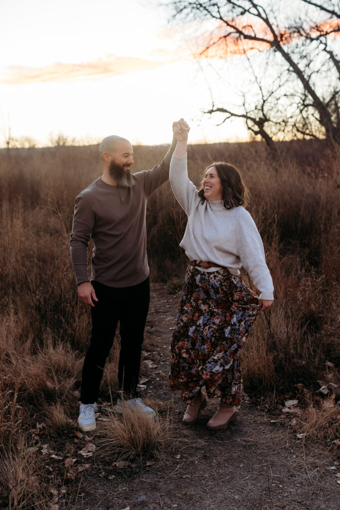 Father twirling mother by Brighton Family Photographer